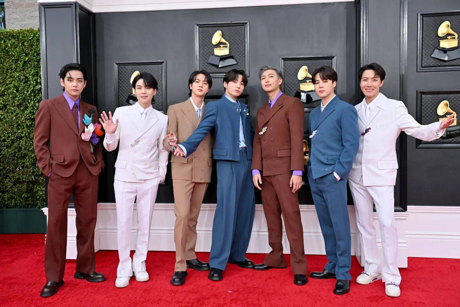 BTS receiving an award as Recording Academy CEO Harvey Mason Jr. responds to their Grammy decision