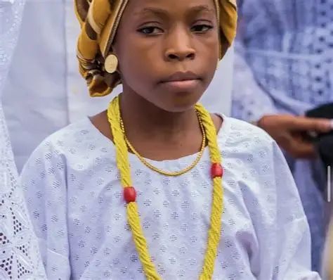 Ten-year-old Princess Alimot Osunbunmi carrying the sacred calabash during the Osun-Osogbo Festival