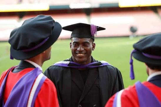 Taiwo Awoniyi wearing a graduation gown after earning his UK degree