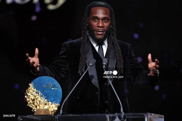 Burna Boy presenting the 2026 Sócrates Award to Arsenal winger Bukayo Saka at the Ballon d'Or ceremony in London.