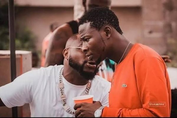 Davido and his aide Dre pictured together in a photograph accompanying reports of a missing phone at Zlatan's wedding.