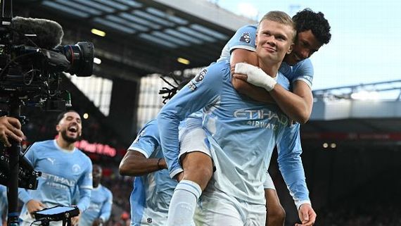 Manchester City players celebrate their 3-0 Premier League victory over Liverpool at Anfield